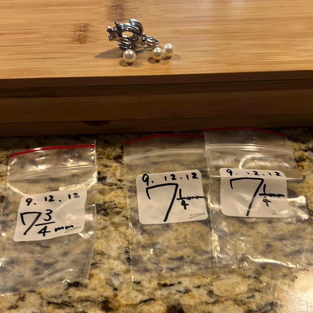 Pearls with sterling silver charm to hold them.